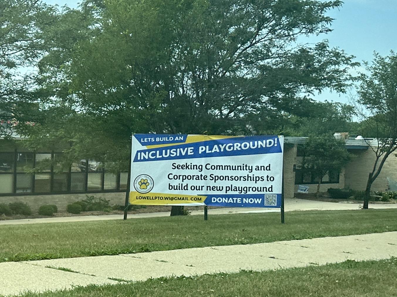 Sign in front of Lowell Elementary that says "Let's build an inclusive playground!"